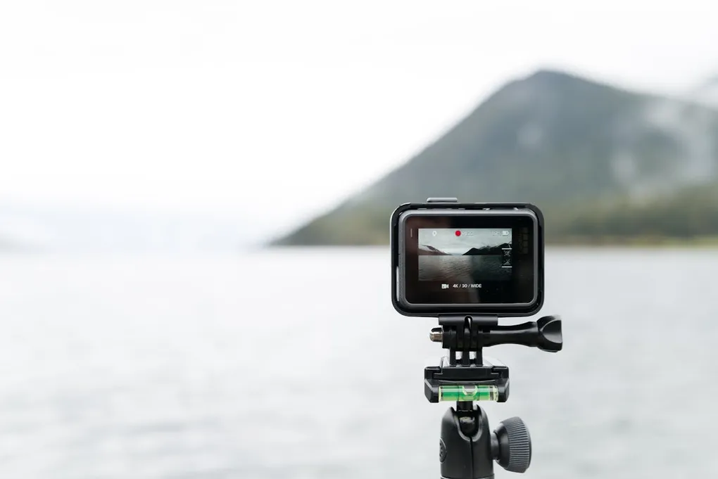 A close-up of an action camera filming a serene lake in Bay of Plenty. Stock Photo